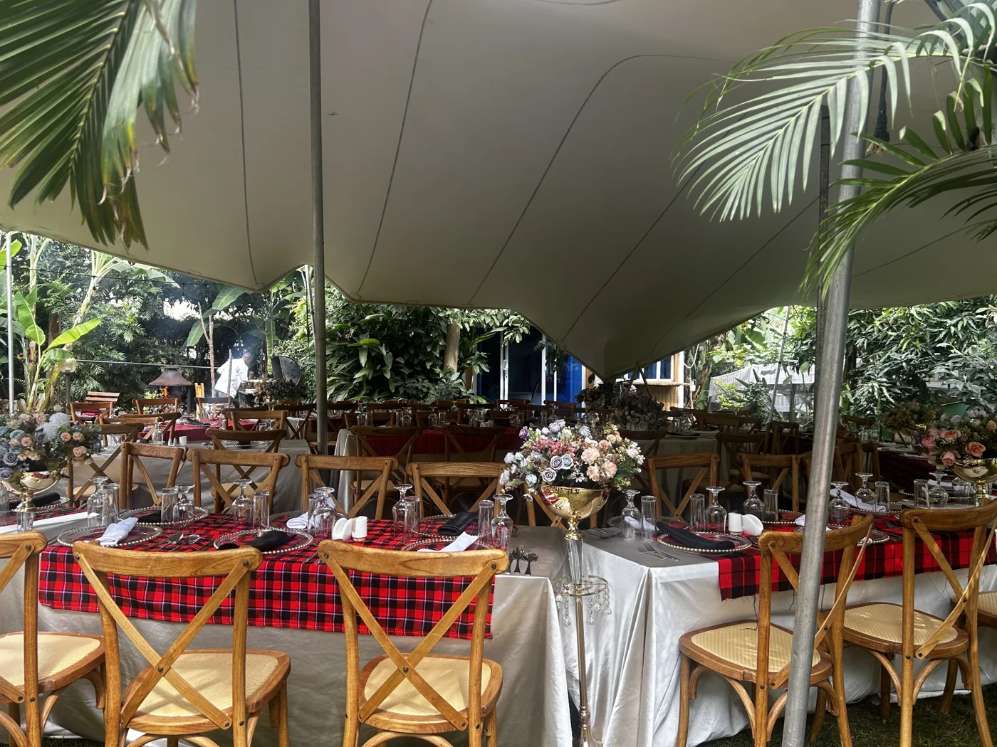 Outdoor dining tables beneath a canopy at Bonsai Villas